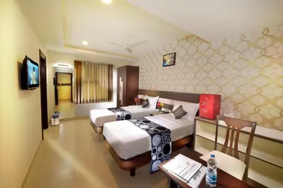 a hotel room with two beds and a table at HOTEL THE FORTUNE in Coimbatore