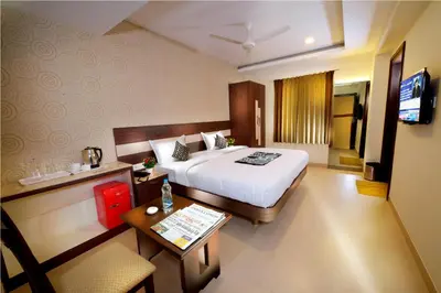 a hotel room with a bed and a table at HOTEL THE FORTUNE in Coimbatore