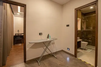 a room with a desk with a laptop on it at Windstone Residency in Coimbatore