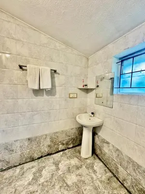 a bathroom with a toilet and a sink at Coorg Nest Cottages By Dreamy Vacations in Kushālnagar