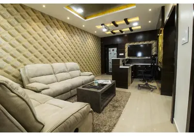 a living room with a couch and a desk and a television at SR BOUTIQUEE STAY in Coimbatore