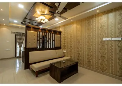 a living room with a couch and a ceiling fan at SR BOUTIQUEE STAY in Coimbatore