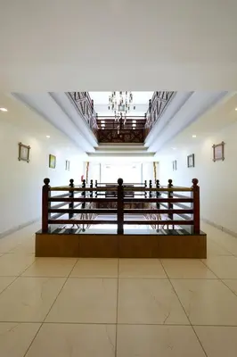 a room with a bench in the middle of a building at Velan Temple View in Palani