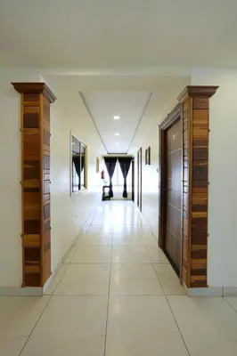 a hallway of a house with wooden cabinets and a hallway sidx sidx sidx at Velan Temple View in Palani