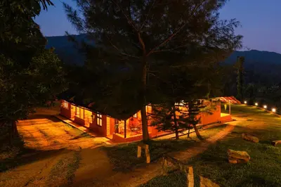 a small house with a tree in front of it at Zostel Homes Wayanad, Thirunelly in Wayanad