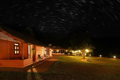 a night view of a building with a starry sky at Zostel Homes Wayanad, Thirunelly in Wayanad