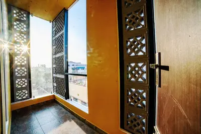 an open door in a room with a window at Sarvam Serviced Apartment in Coimbatore