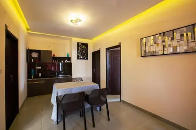 a dining room with a table and chairs at Sarvam Serviced Apartment in Coimbatore