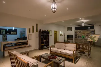 a living room with a couch and a table at Dhole's Den Bandipur in Bandipūr