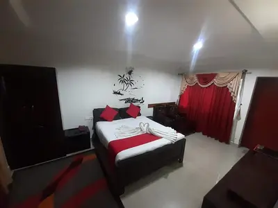 a bedroom with a bed and a flat screen tv at kurinji residency in Ooty