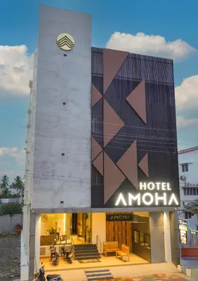 a hotel amritsa building with a sign on it at Hotel Amoha in Palani