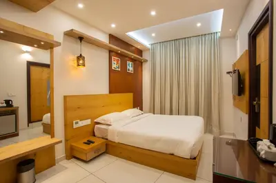 a bedroom with a bed and a television in it at Hasco Tower in Palakkad