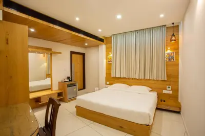 a bedroom with a bed and a large window at Hasco Tower in Palakkad
