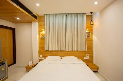 a bedroom with a large bed and a window at Hasco Tower in Palakkad