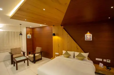 a bedroom with a bed and a wooden wall at Hasco Tower in Palakkad
