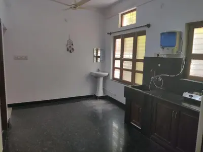 an empty bathroom with a sink and a mirror at Yoga House in Vānivilāsa Puram