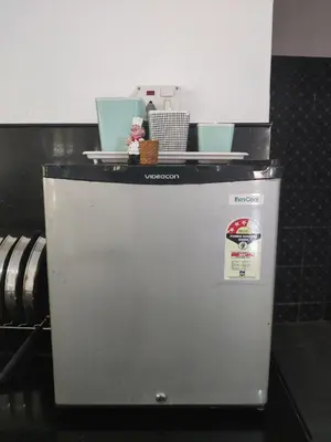 a refrigerator with a sign on top of it at Yoga House in Vānivilāsa Puram
