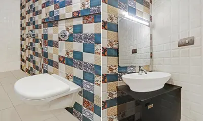 a bathroom with a toilet and a sink at Sreepathi Mayoogha in Guruvāyūr