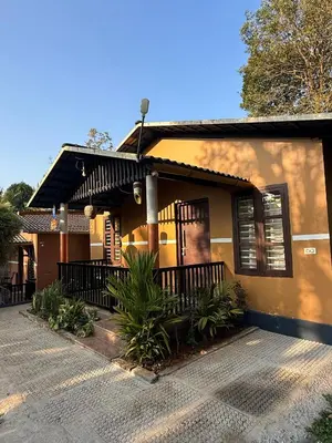 a house with a porch and a driveway at Wayanad Cocos Villa in Tariyod