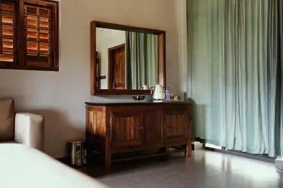 a bathroom with a sink and a mirror on the wall at BARSATI Ranches in Vythiri