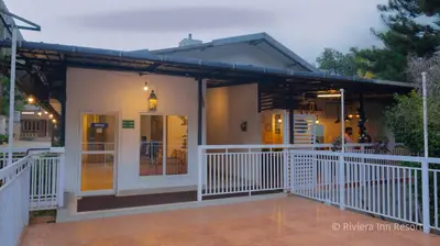 a house with a white fence and a porch at Riviera inn resort in Chillithodu