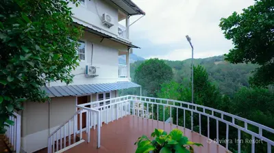 a balcony of a house with a view of the mountains at Riviera inn resort in Chillithodu
