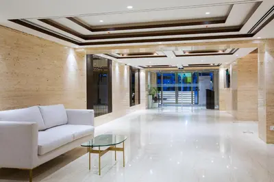 a living room with a couch and a table at IKON By Annapoorna in Coimbatore