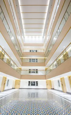 an empty room with a large ceiling and a tiled floor at IKON By Annapoorna in Coimbatore