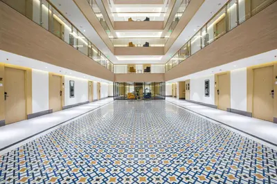 an empty hallway with a tile floor in a building at IKON By Annapoorna in Coimbatore