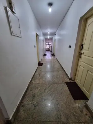 an empty hallway with a door and a hallwayngth at Royal Mist in Ooty