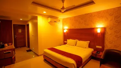 a bedroom with a bed in a hotel room at National Residency in Mysore
