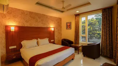 a hotel room with a bed and a window at National Residency in Mysore