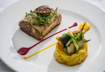 a plate of food with meat and vegetables on it at MOUNTAIN SHADOWS RESORT Wayanad in Wayanad