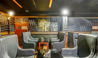 a dining room with chairs and a table and a painting at Treebo Symphony Hotels And Resorts Angamally in Kizhake Chālakudi