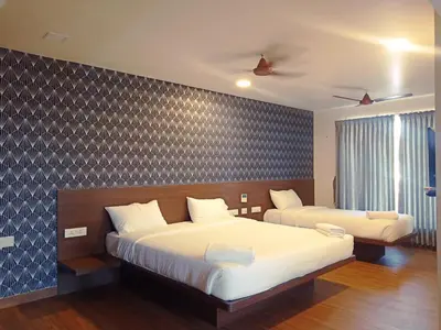 a bedroom with two beds and a wall at HOTEL VINTAGE CASTLE in Coimbatore