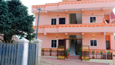 a pink house with a fence in front of it at The Coorg Heaven in Madikeri