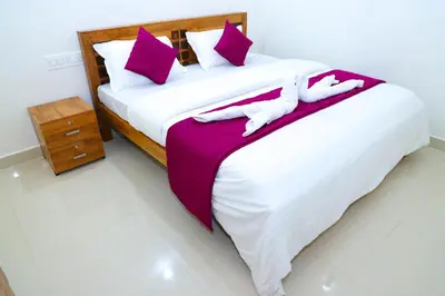 a bedroom with a large bed with purple and white pillows at The Coorg Heaven in Madikeri