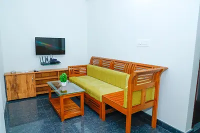 a living room with a couch and a tv at The Coorg Heaven in Madikeri