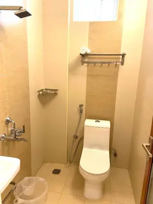 a bathroom with a toilet and a sink at TAG HOTELS in Irugūr