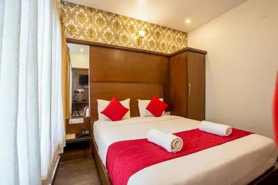 a bedroom with a large bed with red pillows at The Baron in Ooty