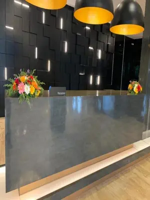 a reception counter with flowers on top of it at Fezinn Hotel - Best Wayanad Hotel in 2024 in Kozhikode