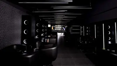 a dark room with a row of urinals in a bathroom at The Arcadia Coimbatore Airport in Coimbatore