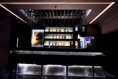 a bar with a lot of bottles of alcohol at The Arcadia Coimbatore Airport in Coimbatore