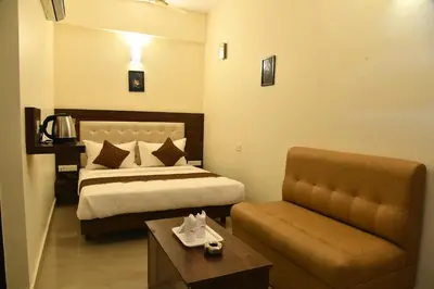 a hotel room with a bed and a couch at ADVAITHA RESIDENCY in Mysore