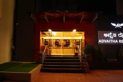 an entrance to a restaurant with stairs leading to the door at ADVAITHA RESIDENCY in Mysore