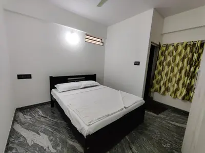 a bedroom with a bed in a room at Vogel's Nest in Mysore
