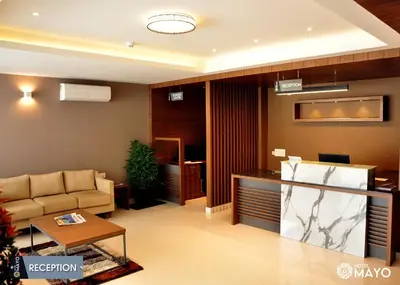 a living room with a couch and a table at Hotel Mayo in Wayanad