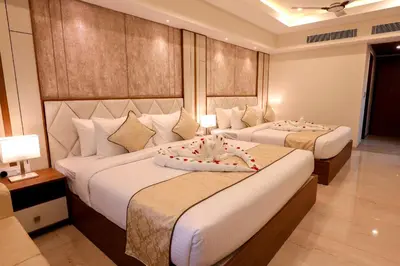 a hotel room with two beds in a room at Krishnavalsam Regency in Guruvāyūr