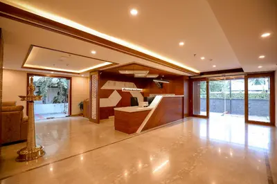 a large room with a kitchen and a living room at Krishnavalsam Regency in Guruvāyūr