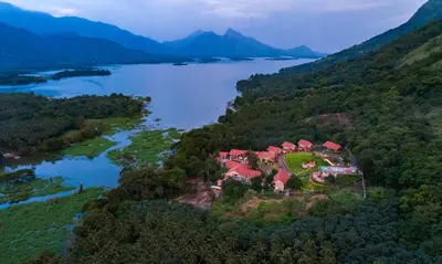 an aerial view of a house on a hill next to a lake at Au Revoir Wellness Resort, Malampuzha in Palakkad